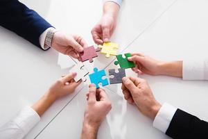 Teamwork of partners. Concept of integration and startup with puzzle pieces photo