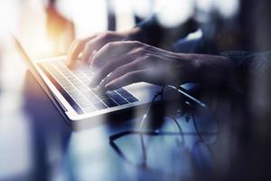 Business man works in office with laptop. Concept of internet network. double exposure photo
