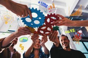 Business team connect pieces of gears. Teamwork, partnership and integration concept photo