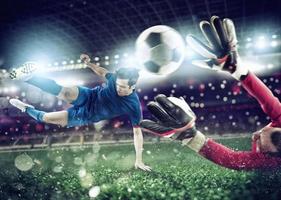 Goalkeeper catches the ball in the stadium during a football game. photo