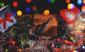 Desk with presents and a blank letter to santa claus photo