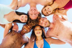 Happy smiling friends at the beach photo