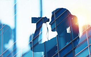 Businessman looks for new job opportunities with binoculars. double exposure photo