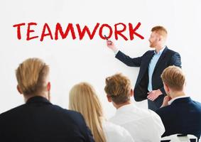 Businessman in office explain something about teamwork at a training meeting photo