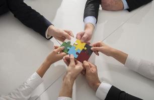 Teamwork of partners. Concept of integration and startup with puzzle pieces photo