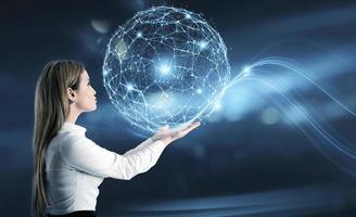 Businesswoman holds an abstract world with internet connection network effect photo