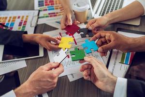 Teamwork of partners. Concept of integration and startup with puzzle pieces photo