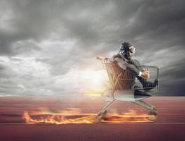 Businessman runs fast driving a cart with rocket during a competition photo