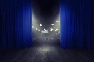 The blue curtains are opening for the theater show photo