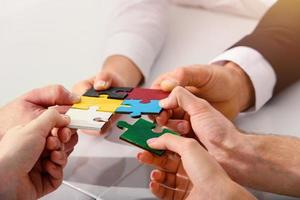 Teamwork of partners connect puzzle pieces as integration and startup photo