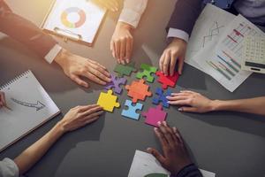 Teamwork of partners. Concept of integration and startup with puzzle pieces photo