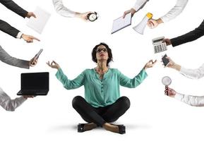 Businesswoman tries to keep calm with yoga due to stress and overwork at wok photo