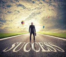 Man walks on a success way. Concept of successful businessman and company startup photo
