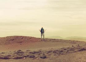 Uncertain explorer is lost in a desert. photo