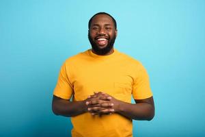 Joyful and happy man over cyan background photo