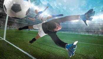 Goalkeeper catches the ball in the stadium during a football game photo