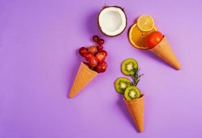 Ice cream with natural fruits. Concept of genuine and biologic fruit. Purple background photo