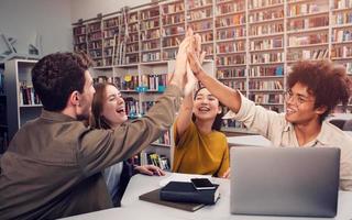 University students putting their hands together. concept of teamwork and partnership photo