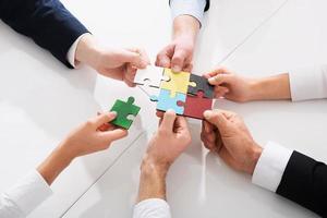 Teamwork of partners. Concept of integration and startup with puzzle pieces photo