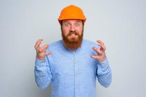 Isolated anger architect with beard and orange helmet