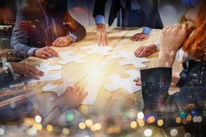 Teamwork of partners connect puzzle pieces as integration and startup photo