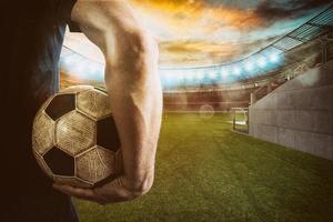Soccer player ready to play with ball in his hands at the exit of the locker room tunnel photo