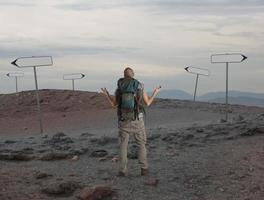 Uncertain explorer is lost in a desert photo