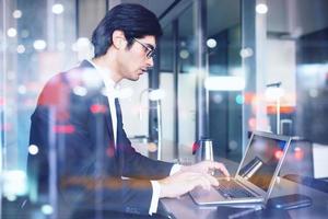 Businessman works at home with a laptop. concept of internet sharing. Double exposure photo