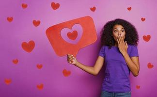 Woman is happy because receives hearts on social network photo