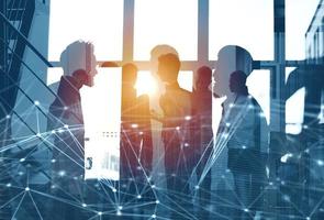 Business people work together in office with internet network effects. Concept of teamwork and partnership. double exposure photo