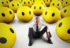 Alone desperate businessman in the middle of happy smileys . 3D Rendering photo