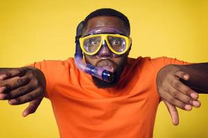 Man with mask ready to swim underwater. yellow background photo