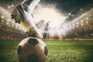 Close up of a soccer striker ready to kicks the ball at the stadium photo