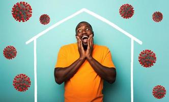Concept of stay at home message with a man inside his house and around outside covid 19 coronavirus photo