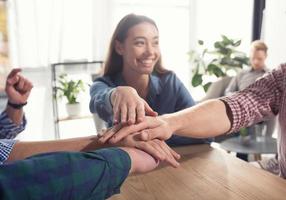 Business people putting their hands together. Concept of teamwork and partnership photo