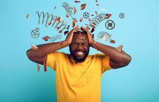 Boy with stressed and exhausted expression is desperate. cyan background photo