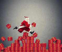 Santa Claus goes fast over Christmas gift photo