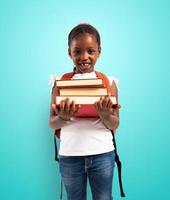 Young girl holds book and is ready to go at school photo