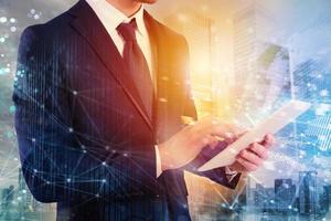 Businessman shares document with tablet. Internet network effect on background photo