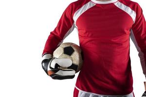 Goalkeeper holds the ball in the stadium during a football game. Isolated on white background photo