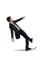 Businessman slips on a banana peel. concept of unlucky and failure photo