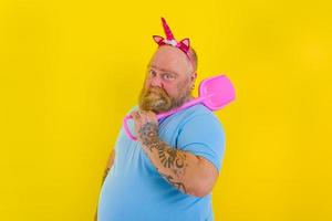 fat man with headband play with sea paddle photo