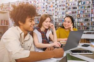 University students are studying in a library together as teamwork for preparation photo