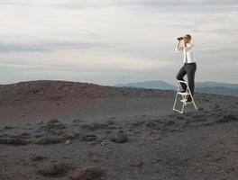 empresario Mira lejos para nuevo negocio oportunidades con un telescopio foto