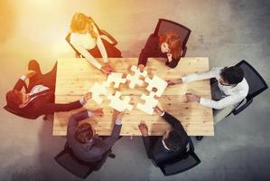 Teamwork of partners. Concept of integration and startup with puzzle pieces photo