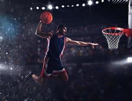 Basket player throws the ball at the stadium photo