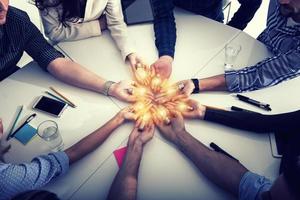 Teamwork and brainstorming concept with businessmen that share an idea with a lamp. Concept of startup photo
