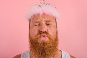 man with beard , tattoos and crown acts like a princess photo