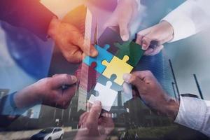 Teamwork of partners. Concept of integration and startup with puzzle pieces. double exposure photo