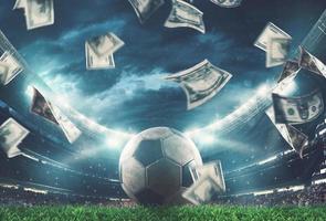 Banknotes raining on the soccer field. Business in the sports world photo